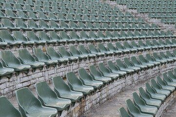Fototapeta premium Rows of empty plastic chairs for open-air theater audiences