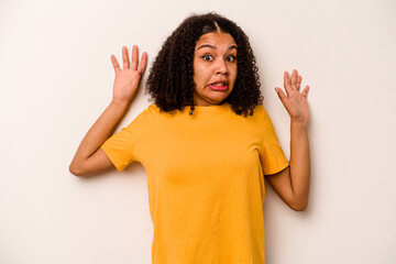 Young African American woman isolated on white background being shocked due to an imminent danger