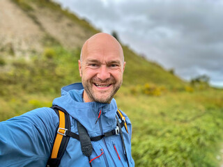 Happy looking Man at the Rügen Island vacation area hiking along the herb coast
