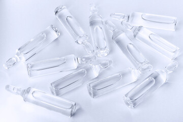 Medical Glass ampoules for injection with pharmaceutical product. Scattered glass ampoules with...