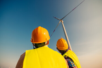 Engineers looking and checking wind turbines