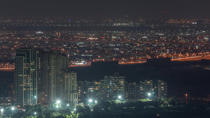 Fototapeta na wymiar Aerial view of greens district area night timelapse from Dubai marina.