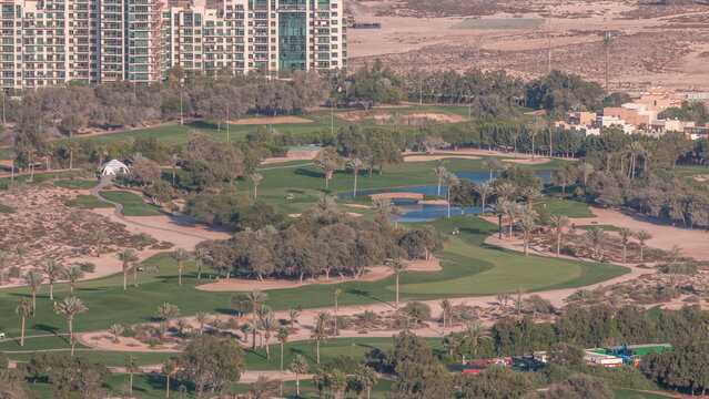 Aerial View To Golf Course With Green Lawn And Lakes, Villa Houses Behind It Timelapse.