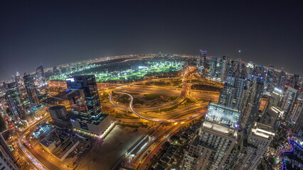 Fototapeta premium Dubai marina and JLT skyscrapers along Sheikh Zayed Road aerial night timelapse.