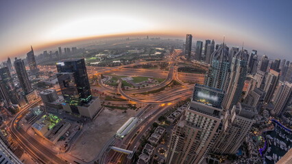 Dubai marina and JLT skyscrapers along Sheikh Zayed Road aerial night to day timelapse. - obrazy, fototapety, plakaty
