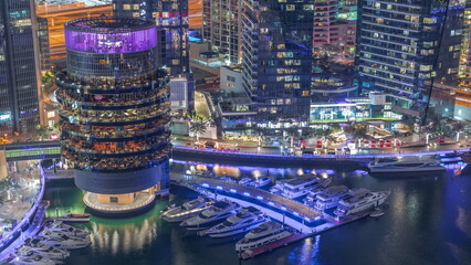 Dubai marina waterfront and building with different restaurants at each floor aerial night...