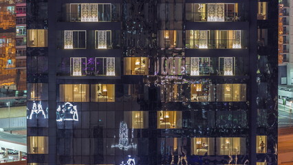 Windows lights in modern towers and residential buildings timelapse at night