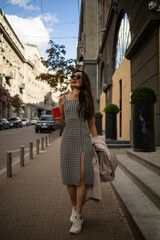 Young trendy asian woman having fun while walking outdoor in europe center city of Ukraine.