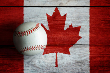 Leather Baseball on Rustic Wooden Background Painted With Canadian Flag