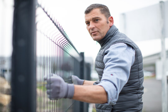 man working on a fence