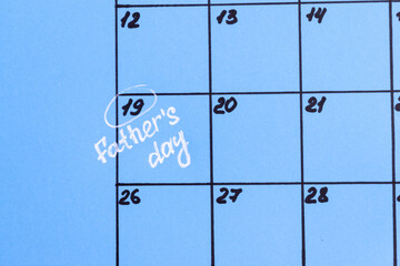 The calendar marks June 19 as Father's Day. Holiday. Mark the holiday on the calendar. Close-up.