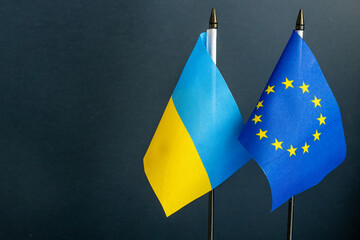 Flags of Ukraine and the European Union, Concept of cooperation and assistance, Place for text - obrazy, fototapety, plakaty