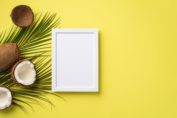 Summer holidays concept. Top view photo of white photo frame coconuts and palm leaves on isolated...