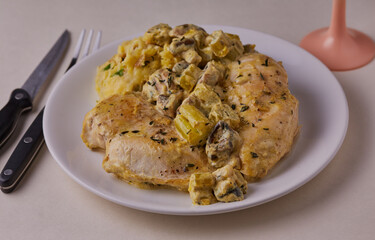 Chicken breasts in creamy white wine sauce with mashed potatoes.