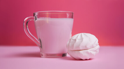 milk drink and marshmallows on a pink background