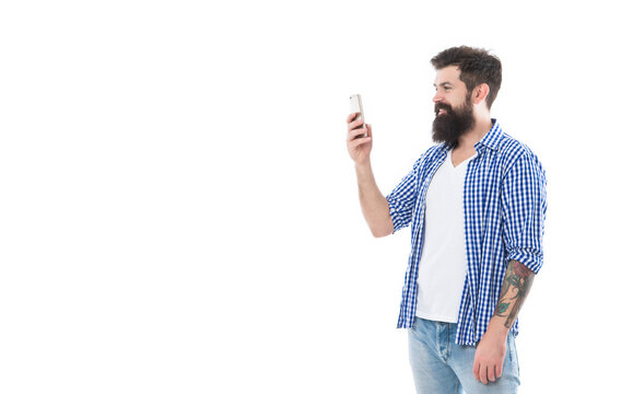 happy brutal bearded man taking photo with phone isolated on white background with copy space
