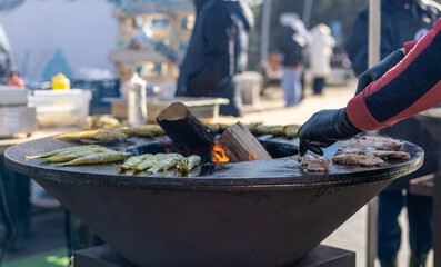 Smelt fish is fried on a large grill during the fish festival in Svetlogorsk Raushen, Kalinigrad region, Russia, near the Baltic sea. 