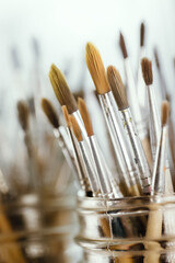 Group of old used paintbrushes with clean background,soft focus and shallow depth of field composition.
