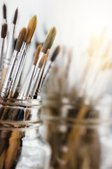 Group of old used paintbrushes with clean background,soft focus and shallow depth of field composition.