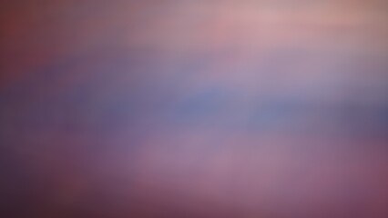 Abstract blur background purple, green, black, red orange gives a moody, gloomy, sad and scary mood.