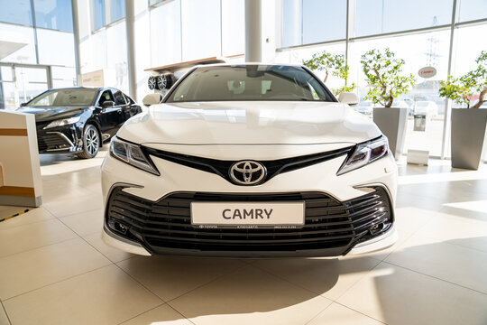 new white car Toyota camry in premises of the dealership of Toyota cars. 
