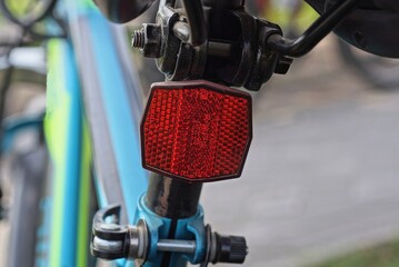 one red plastic warning light on a black blue sports bike in the street