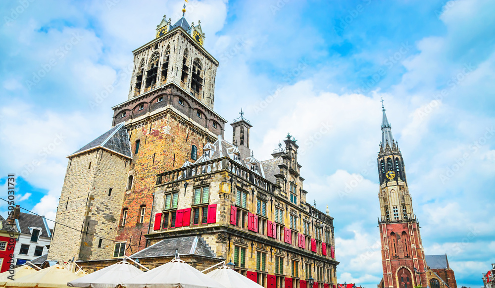 Wall mural nieuwe kerk tower and town hall on market square of old beautiful city delft, netherlands