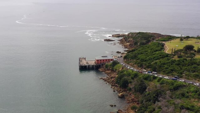 Tathra town beach waterfront to Sapphire coast open sea &ndash; aerial flying 4k.
