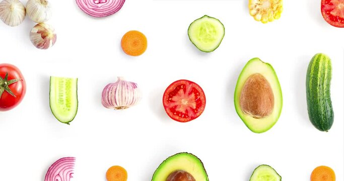 Creative animation made of Vegetables.  Avocado,tomato,garlic,onion,cucumber,carrot,corn,garlic. Vegetables isolated animation on white background. Top view.