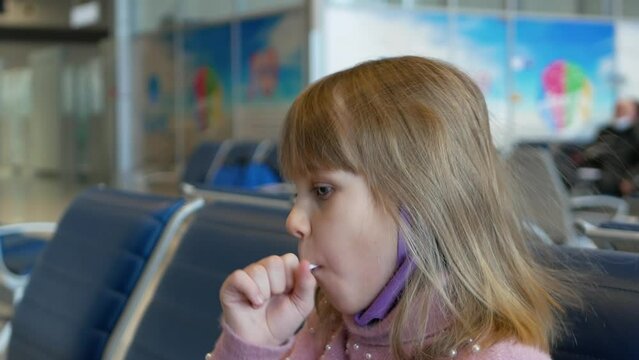 Funny little girl in airport. Child bored wait for journey. Long departure