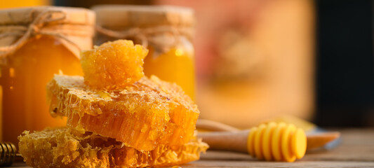 Sweet honey combs on wooden table - obrazy, fototapety, plakaty