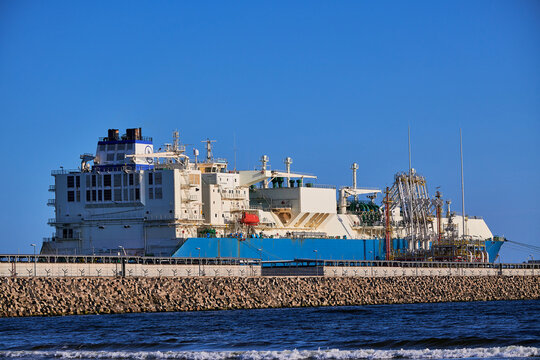 Świnoujście, Poland - May-15-2022: LNG transportation vessel Maran Gas Appolonia while discharging at terminal for liquified gas, connections, equipment and pressure reducers at baltic sea. 