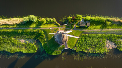 An aerial view of the windmill. Kinderdijk national park. Canals with water for agriculture. Fields...