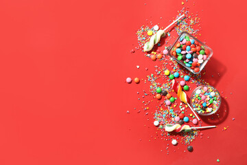 Composition with sweet candies on red background