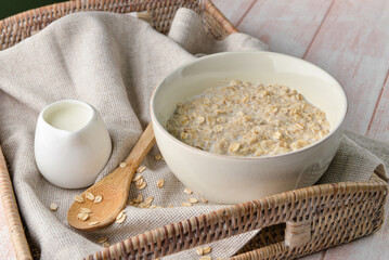 Bowl of tasty oatmeal on table