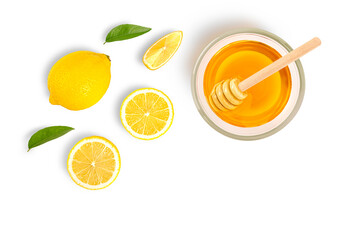 Glass bowl of pure honey with honey dipper and lemon slice isolated on white background. Top view