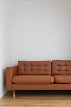 Brown Couch Near Light Wall In Room