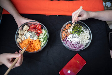 verduras al bowl presentacion, manos sirviendo. palillos chinos.