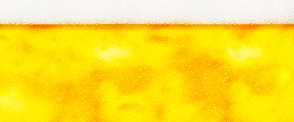 Horizontal background image of draft beer with foam at the top