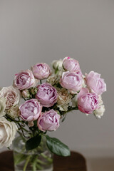 Flowers in a vase on a white background. Peony roses lavender and silver rhine