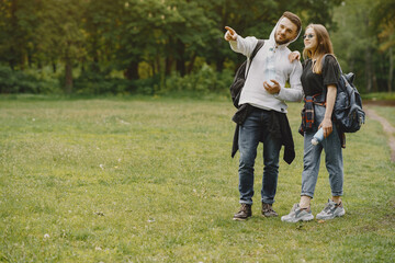 Fototapeta premium Cute couple have a rest in a summer forest