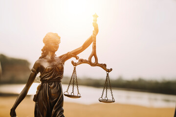 Justice and law concept.Male judge in a courtroom with the gavel, working with, computer and...