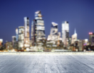 Empty concrete dirty rooftop on the background of a beautiful blurry New York city skyline at...