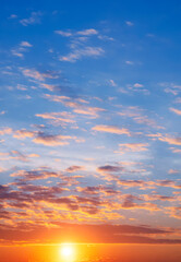 Naklejka na ściany i meble Colorful orange and blue sunset sky background at morning time in vertical frame