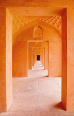 Orange corridor central view of consecutive doors
