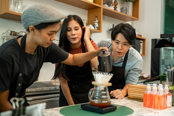 Barista is Making a Cup of Cappuccino in Coffee Shop Bar,Professional barista preparing coffee using chemex pour over coffee maker and drip kettle,Alternative ways of brewing coffee.