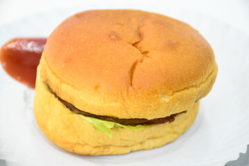 Vegetarian hamburger with fries and red chilli sauce on white background