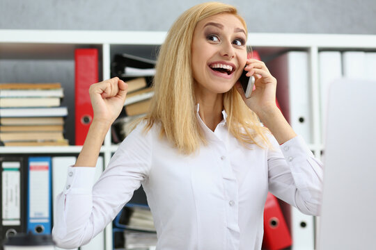Happy worker got good news on phone, chatting during work time, excited to hear