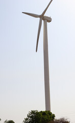 High Shot of Wind turbine with bright sky in background