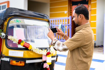 Driver busy taking picture of his new auto Rickshaw before driving to post on social media -...